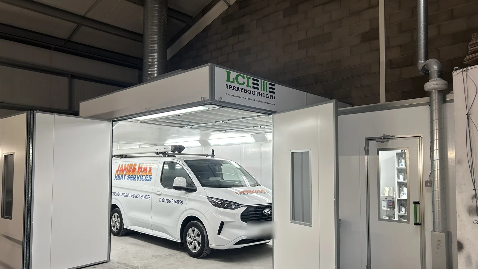 A liveried van entering the Refinish Limited spraybooth, showing the fixed door height that sets the limit on vehicle size